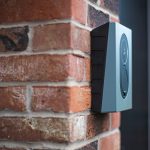 Wall-mounted electricity meter on a brick exterior wall of a UK home